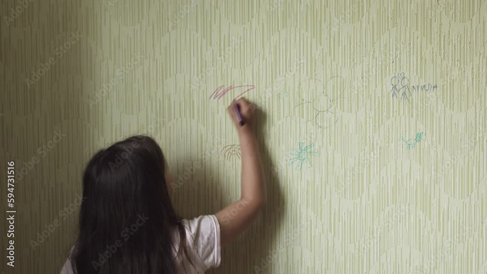 Black haired little girl draw doodle with purple marker on old