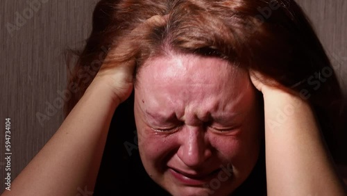 Broken woman hysterically cry and scream pulling hair in dark room closeup. Tears rolling down cheeks. Splash out emotions, weep bitterly. Emotional breakdown, mental health crisis, hysterics.