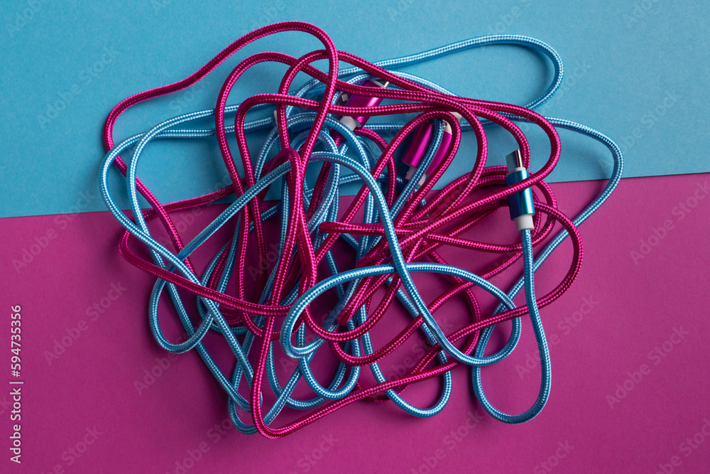 Multicolored USB cables on bright background Multicolored USB cables on bright background