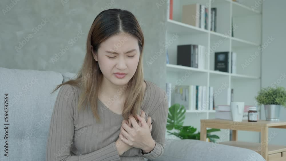 hand hold chest with heart attack symptoms, asian woman have chest pain