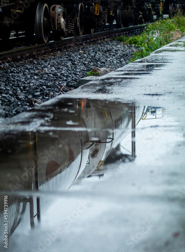 Train vagoon reflecting on a water spot photo