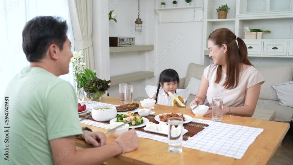Happy Asian family having fun during lunch. Happy Asian family having fun during lunch.