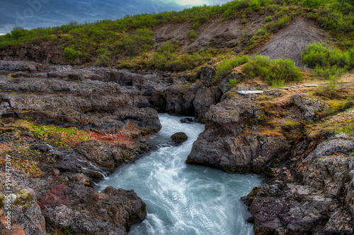 Hraunfossar is a waterfall located in western Iceland, on the Hvitá river,