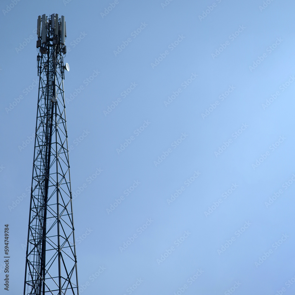 Steel tower with cellular antennas against the blue sky. Steel tower with cellular antennas against the blue sky.
