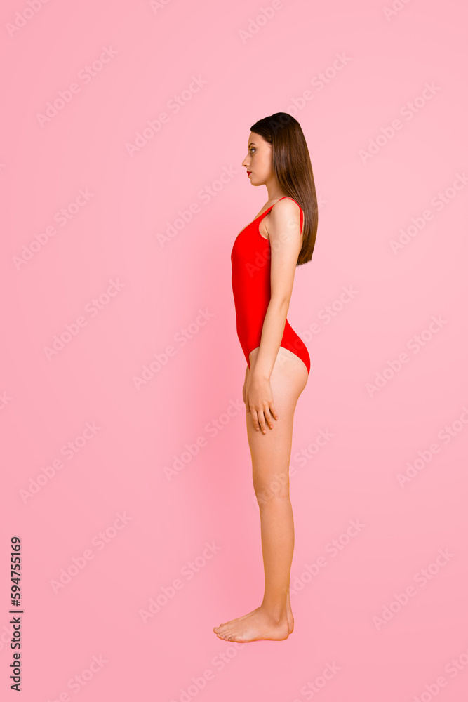 Full length side half turned view photo studio shoot portrait of beautiful attractive charming pretty serious fit slim lady student standing straight on floor isolated bright shiny background Full length side half turned view photo studio shoot portrait of beautiful attractive charming pretty serious fit slim lady student standing straight on floor isolated bright shiny background