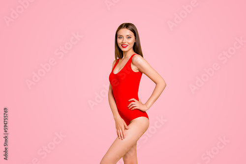 Charming young brunett girl with big smile looking at camera and stand in half turn isolated on vivid yellow background with copy space