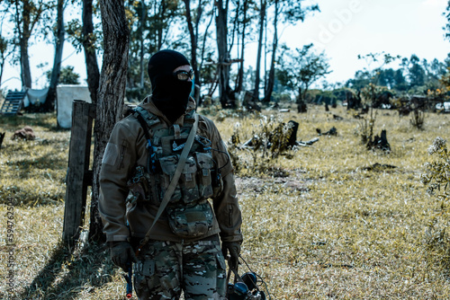 Anonymous soldier with AK-47 in the middle of the battlefield