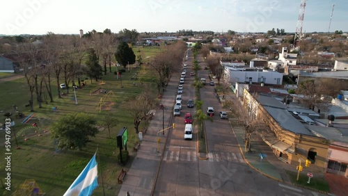 Bandera Argentina Flameando en la plaza central de una ciudad rural, Urdinarrain, Entre Ríos, Argentina  photo