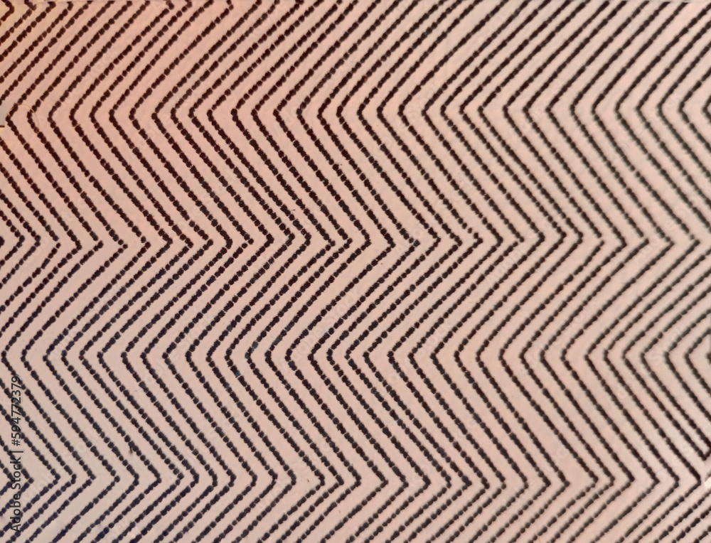 Weaving on a beige background, with dark lines forming a zigzag pattern.