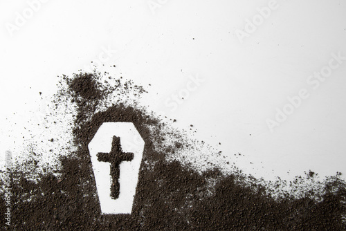 top view of coffin shape with dark soil and cross on white surface grim reaper funeral death