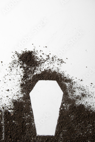 top view of coffin shape with dark soil on the white background grim reaper funeral death