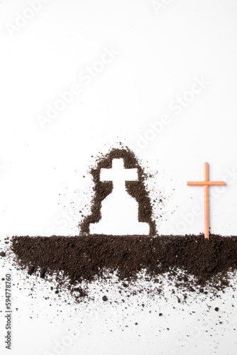 top view of cross shape with dark soil on white surface funeral death grim reaper