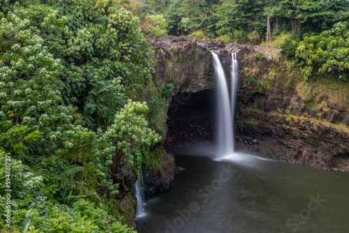 Rainbow  Waianuenue  Falls is a waterfall  Hilo  Hawaii  USA. The Wailuku River rushes into a large pool below.