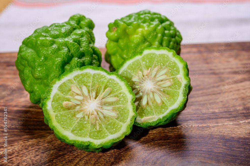 Citrus hystrix, kaffir lime or makrut lime, citrus fruit native to tropical Southeast Asia. essential oil is used in perfumery for intense citrus fragrance. Citrus hystrix, kaffir lime or makrut lime, citrus fruit native to tropical Southeast Asia. essential oil is used in perfumery for intense citrus fragrance.