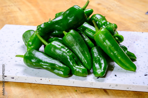 Fresh green mild padron pepper pementos, ready for grill or to be fried with olive oil, traditional snack in Galicia, Spain photo