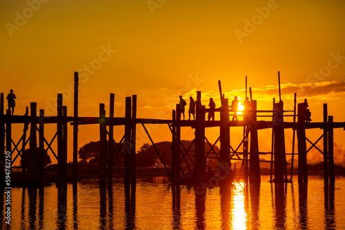 Amarapura  Myanmar - November 22  2016  Unidentified people walk on U Bein bridge at sunset in Myanmar. U Bein bridge is the longest teak bridge in the world.