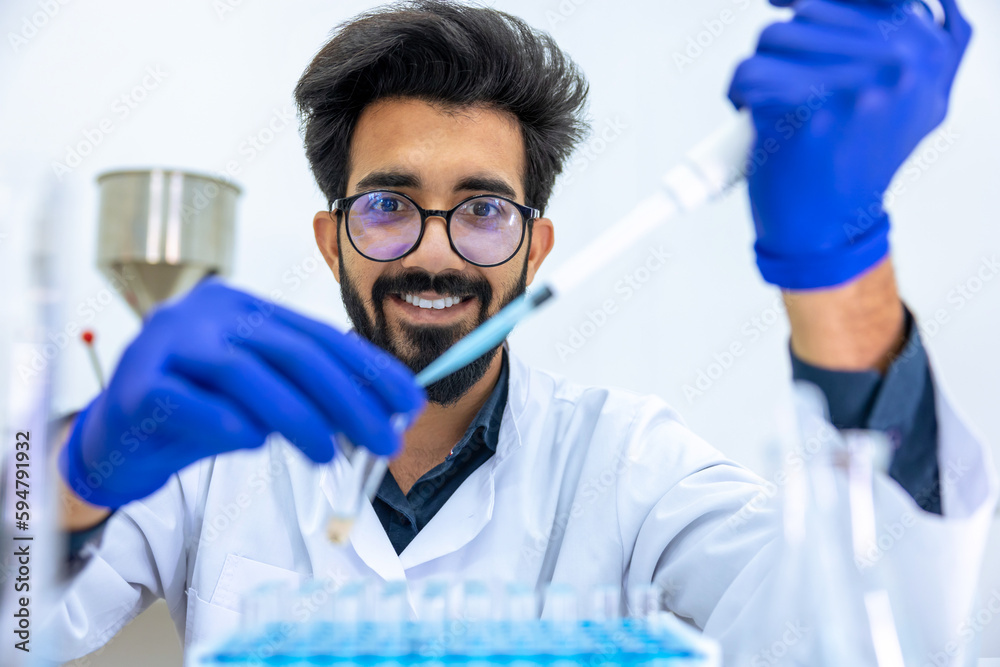 Man scientist dripping chemicals to test tubes, biochemist conducting experiments to discover drugs Man scientist dripping chemicals to test tubes, biochemist conducting experiments to discover drugs