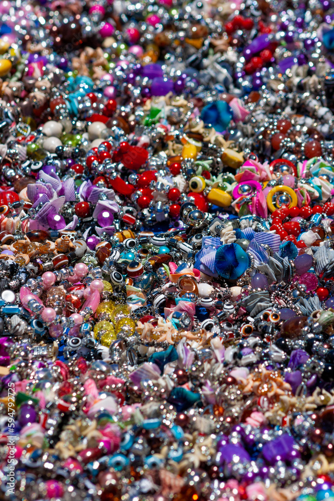 picture-filling mass of jewelry and decorative stones and ornaments in a motley heap