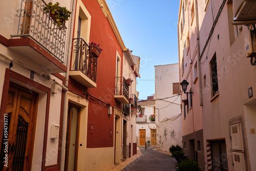 View of colorful buildings and narrow streets, architecture in the historic center of the Mediterranean town of Calpe. Region Valencia in Spain
