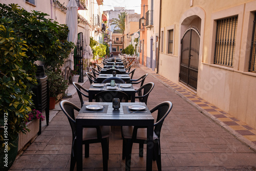 Historic center of the old town of Calpe.Calpe town with colorful houses and restaurant terraces.A place to eat in restaurants on a terrace street.Spain