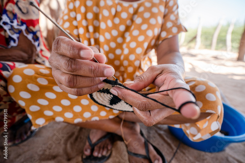 hands of indigenous woman weaving backpack, guajira Colombia
