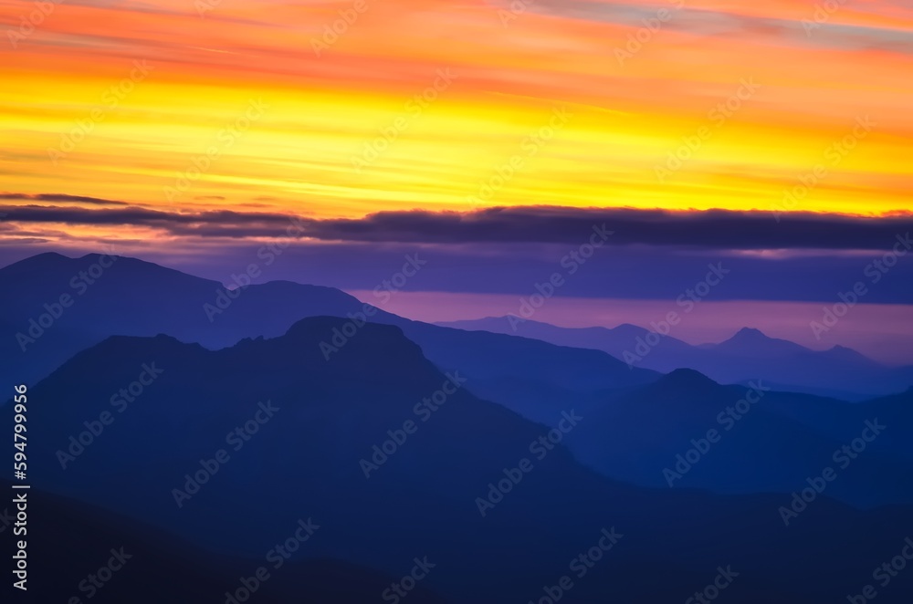 Mountain landscape in autumn evening at sunset. Outstanding view of the mountain ridges in Tatras National Park in Poland during the sun goes down. Photo taken in Giewont Peak, Poland.