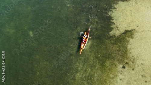 An aerial drone photo of kayaking in the green waters of Dunedin Causeway Tampa Bay, Florida.