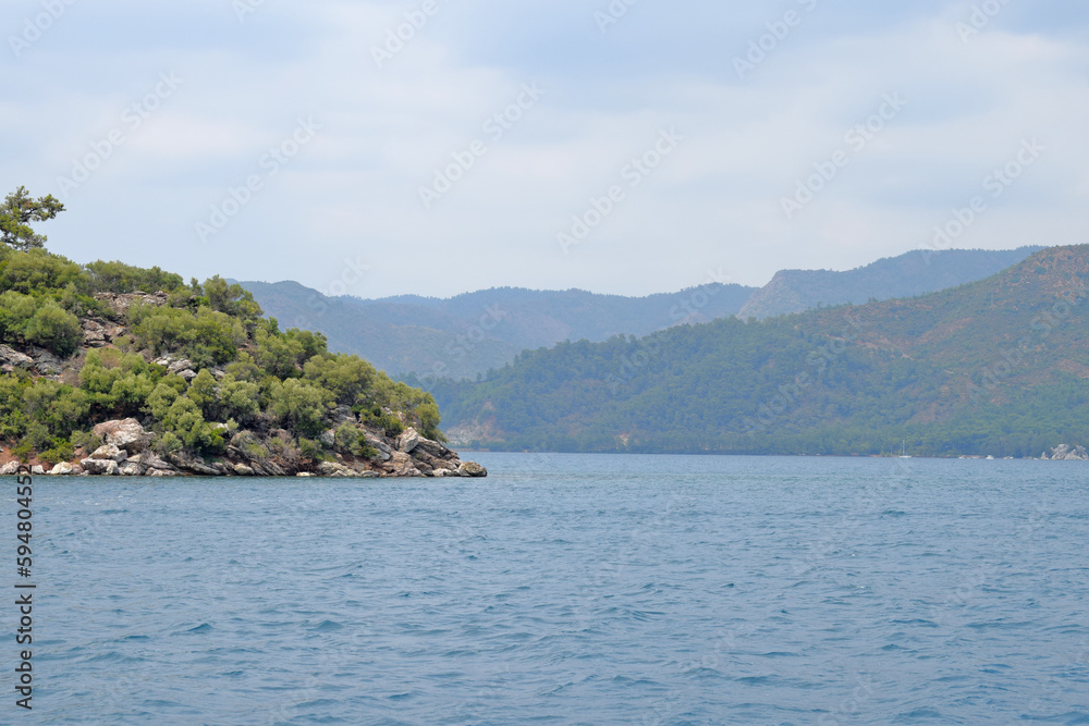 Hills and mountains by the sea. Green mountains and rocks. deserted islands Hills and mountains by the sea. Green mountains and rocks. deserted islands