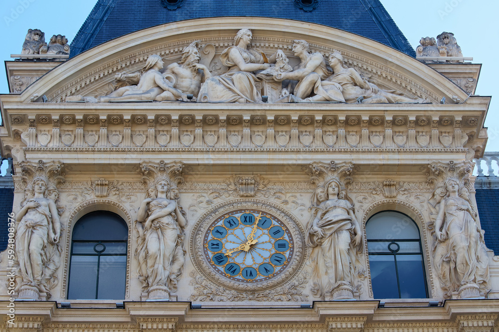 Giant clock on the facade of a building in Paris .