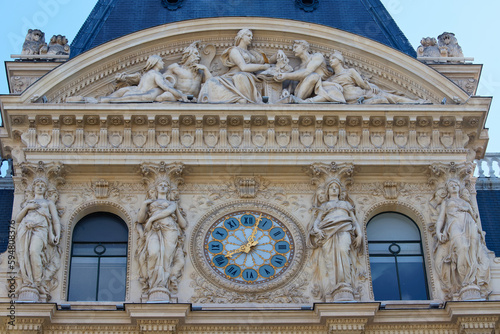 Giant clock on the facade of a building in Paris .