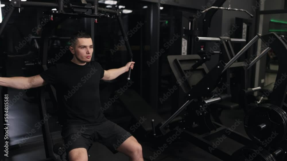 Handsome workout, Chest press, Gym motivation. Attractive, well-built man rigorously trains arms using gym equipment, focusing on chest exercises. Handsome workout, Chest press, Gym motivation. Attractive, well-built man rigorously trains arms using gym equipment, focusing on chest exercises.