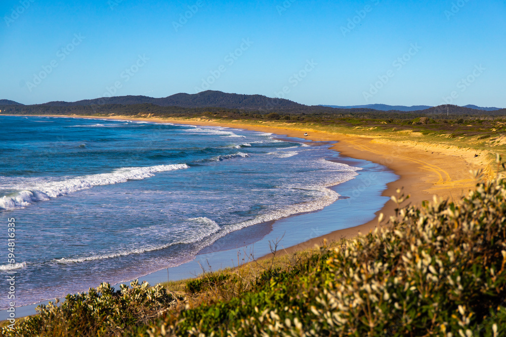 beautiful wooli beach with large waves on the coast of pacific in yuraygir national park, new south wales, australia