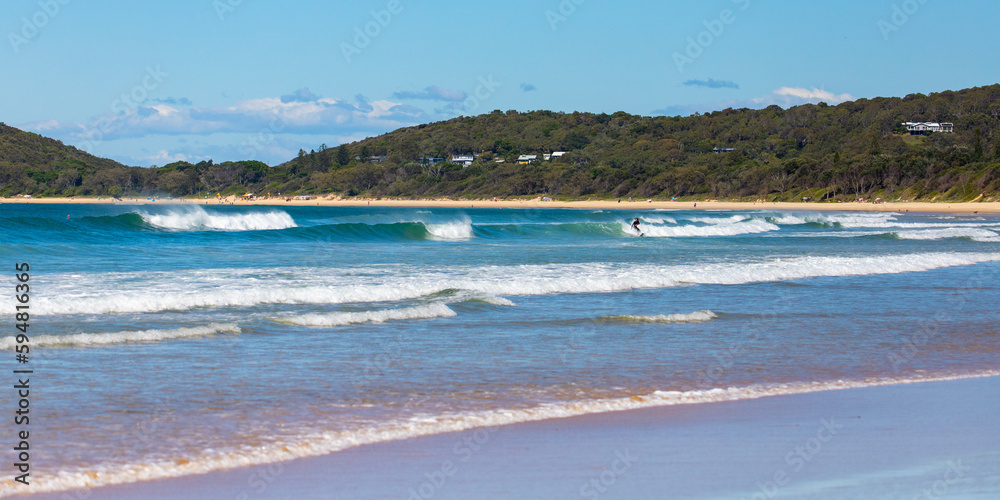 beautiful wooli beach with large waves on the coast of pacific in yuraygir national park, new south wales, australia