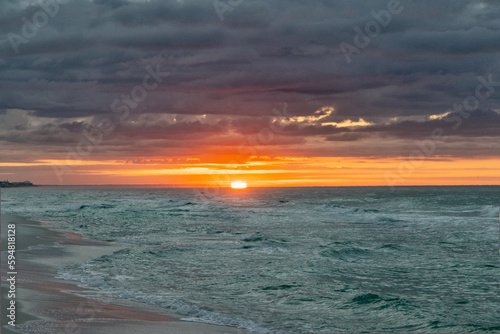 Sunrise on windy morning with the sea churning.