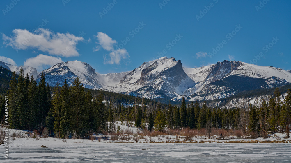 Snowy Mountain Peaks Above Frozen Lake on a Sunny Day