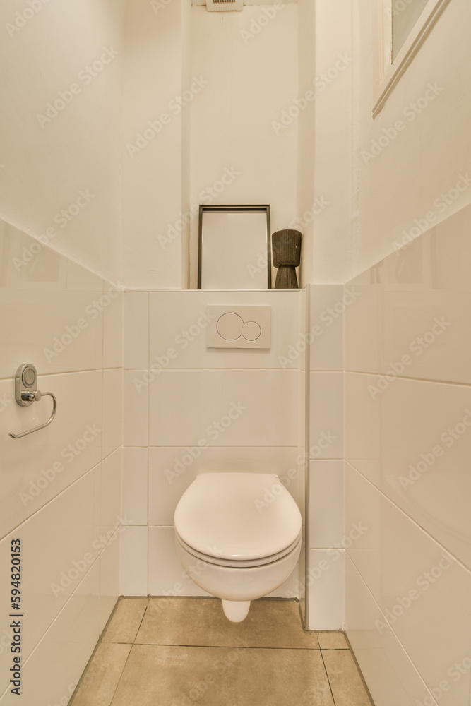 a white toilet in a bathroom with tile flooring and wall mounted mirror above the toilet bowl on the right side a white toilet in a bathroom with tile flooring and wall mounted mirror above the toilet bowl on the right side