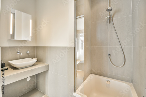 a bathroom with a sink  mirror and bathtub on the wall in this photo is taken at night time