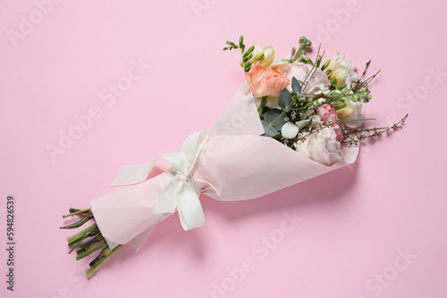 Fototapeta Naklejka Na Ścianę i Meble -  Bouquet of beautiful flowers on pink background, top view