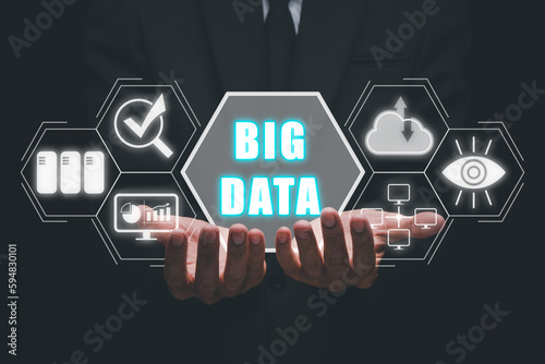 Big data concept, Business person hand holding big data icon on virtual screen.