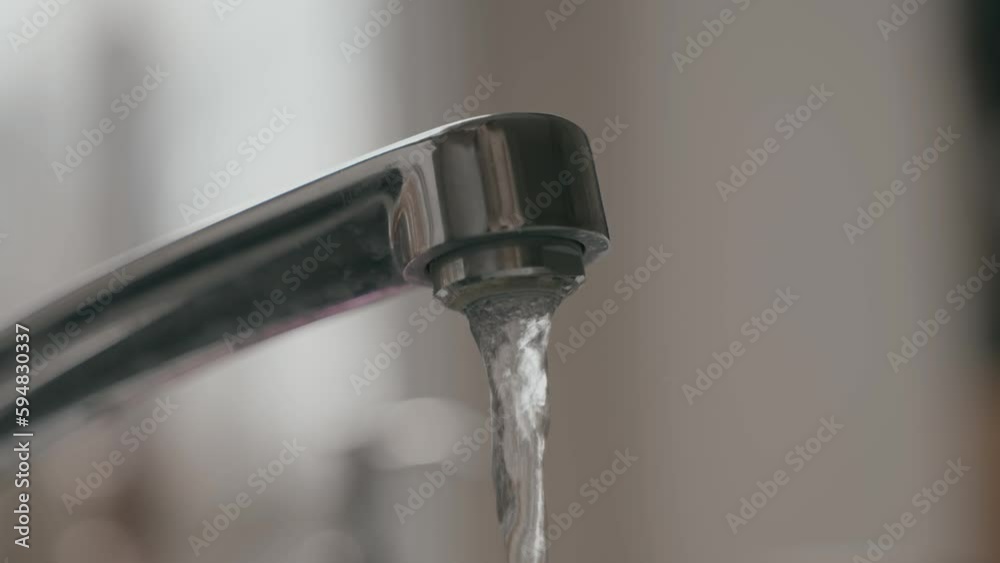 Water coming out of sink in slow motion Water coming out of sink in slow motion