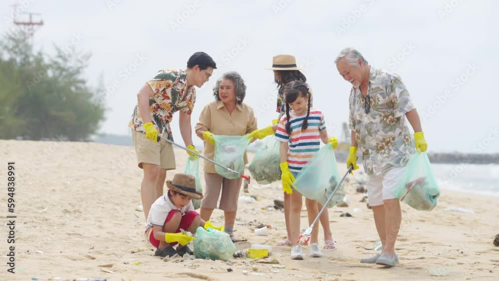 Group of Volunteers multi-Generation family picking up plastic trash and garbage together at the beach on summer holiday vacation. Environmental conservation earth day and waste pollution concept. Group of Volunteers multi-Generation family picking up plastic trash and garbage together at the beach on summer holiday vacation. Environmental conservation earth day and waste pollution concept.