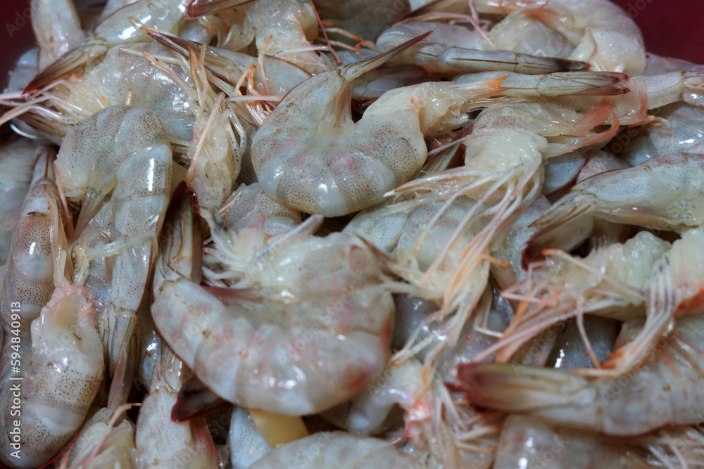 Photo of fresh raw prawns on a plate ready to be cooked