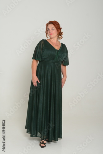 Photo of attractive girl happy positive smile wear glamour dress isolated over blue color background. High quality photo