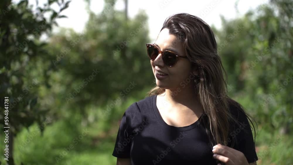 Woman Wearing Sunglasses Walking Around A Fruit Farm - slow motion, close up Woman Wearing Sunglasses Walking Around A Fruit Farm - slow motion, close up