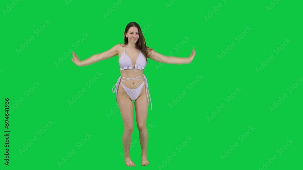 Happy and carefree girl dancing with bikini in front of a green screen chroma key Happy and carefree girl dancing with bikini in front of a green screen chroma key