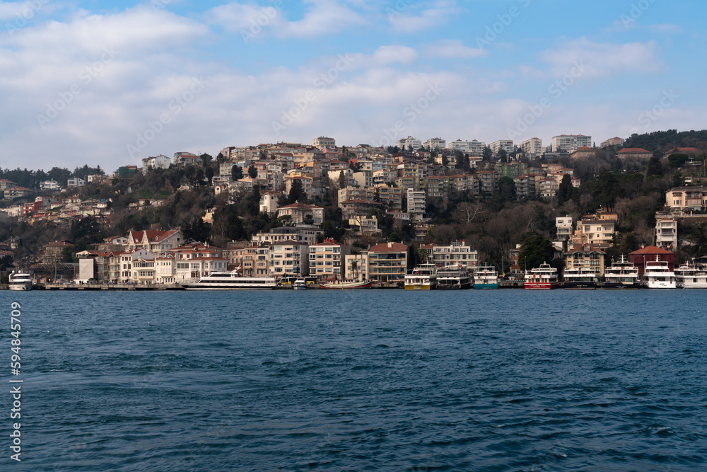 View of the Arnavutkey district of Istanbul on the European part of the city behind the Bosphorus Bridge from the water area of the Bosphorus on a sunny day, Istanbul, Turkey