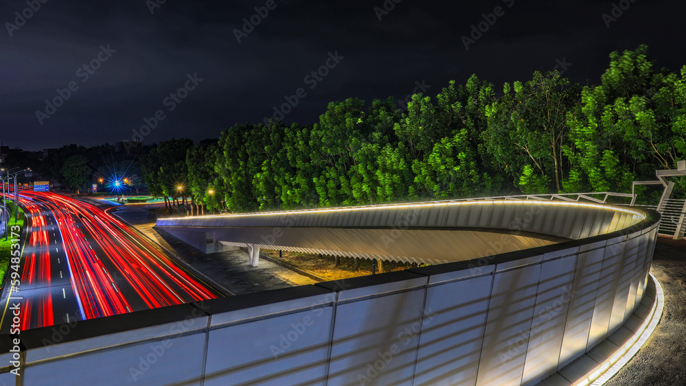 Fototapeta premium Arc-shaped pedestrian viaduct and red beautiful vehicle track,scenic green tree. Chiayi,Taiwan.for branding,calender,postcard,screensave,wallpaper,poster,banner,cover,website.High quality photography