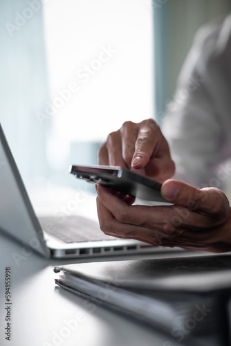 Close up of business man hand using smart phone and tablet. business and technology concept