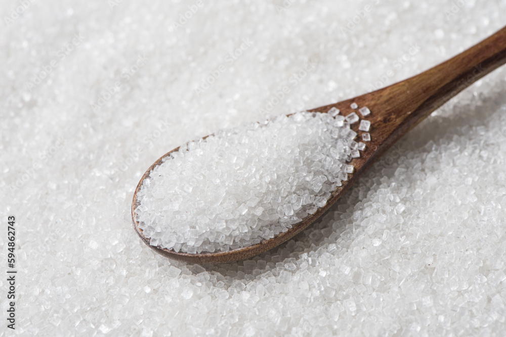 white sugar in spoon texture background. white sugar in spoon texture background.
