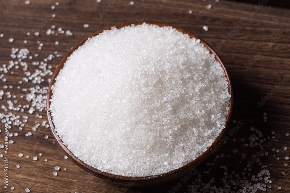 Bowls are filled with sugar on a wooden background Bowls are filled with sugar on a wooden background